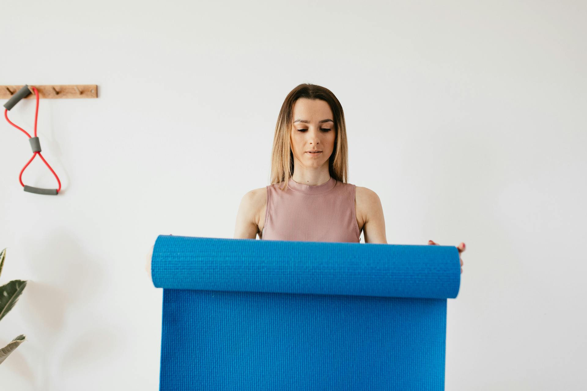 Changing habits - young woman holding a yoga mat