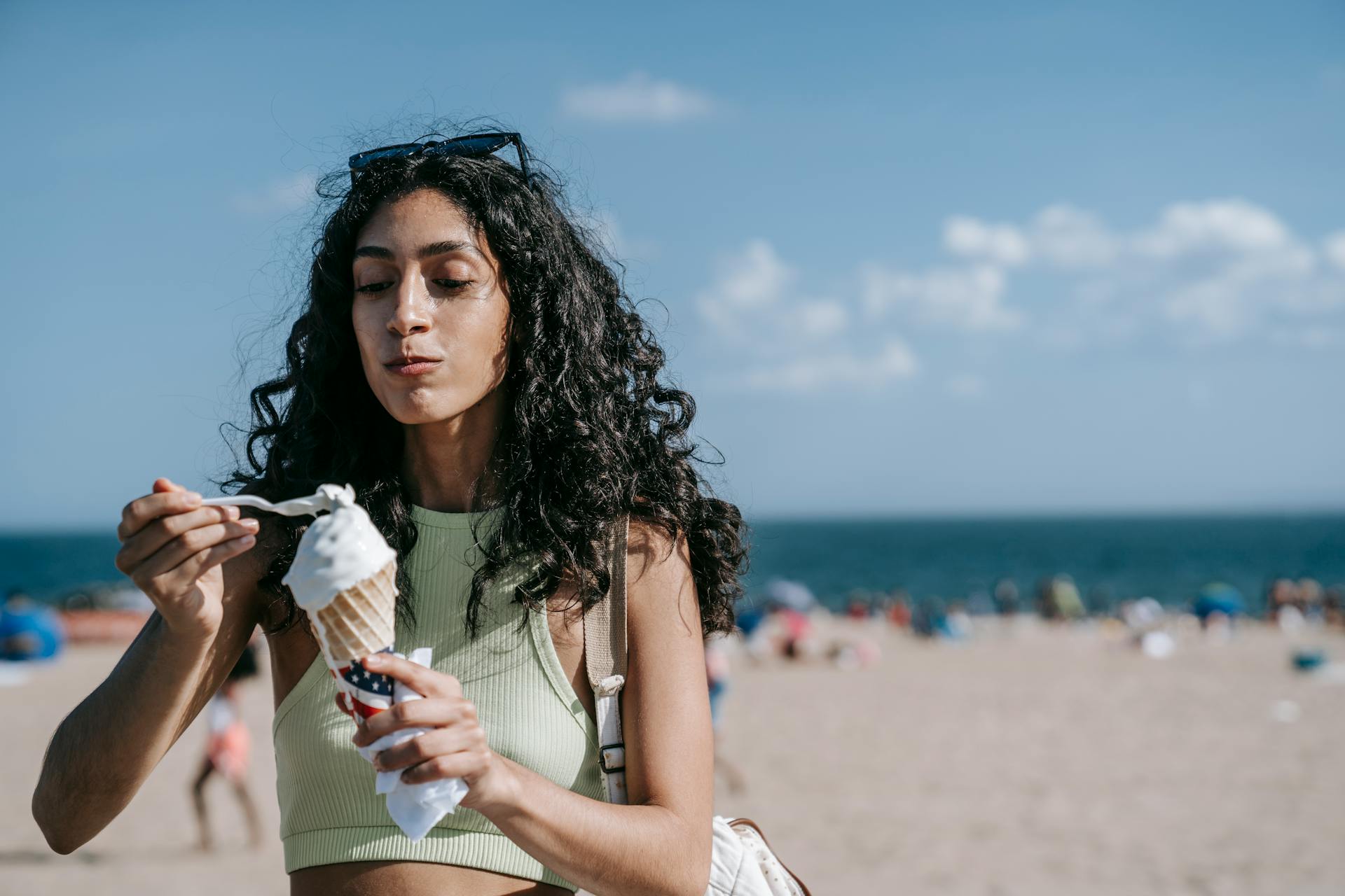 Woman eating ice-cream on the beach